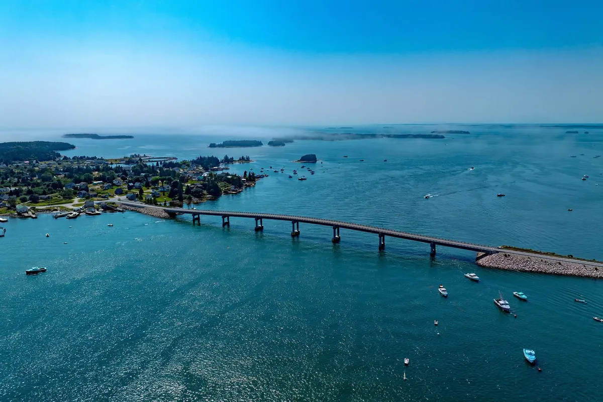 Aerial view of long bridge connecting islands over sparkling Maine bay