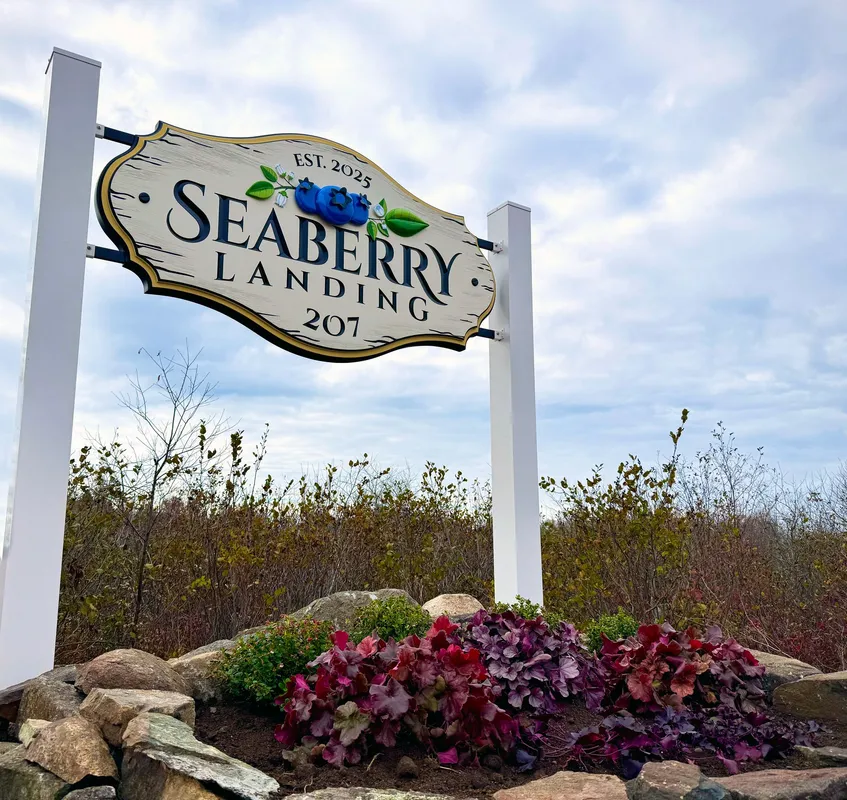 Seaberry Landing entrance sign surrounded by colorful plantings